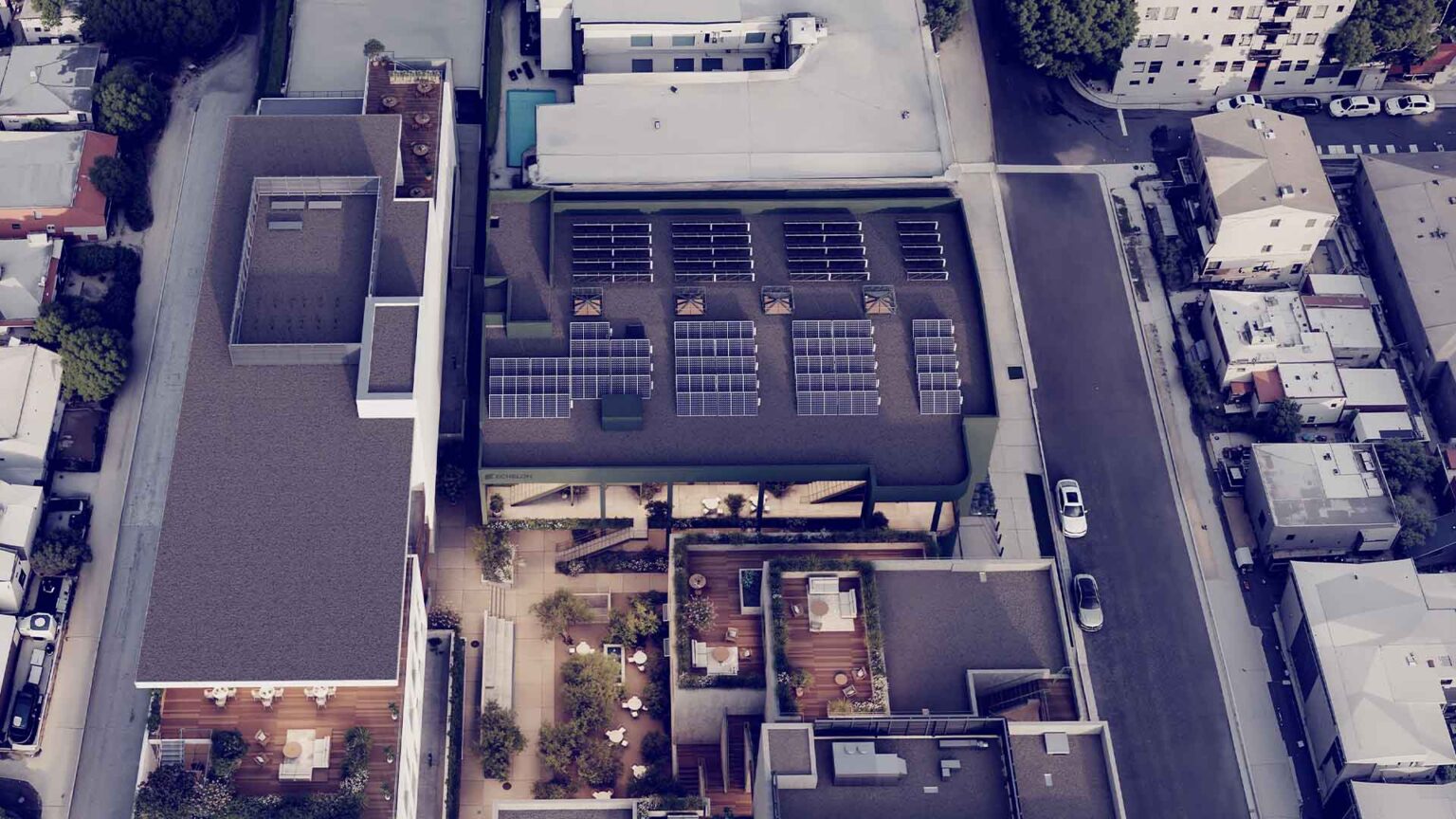 Aerial view revealing solar array and integrated landscape design.