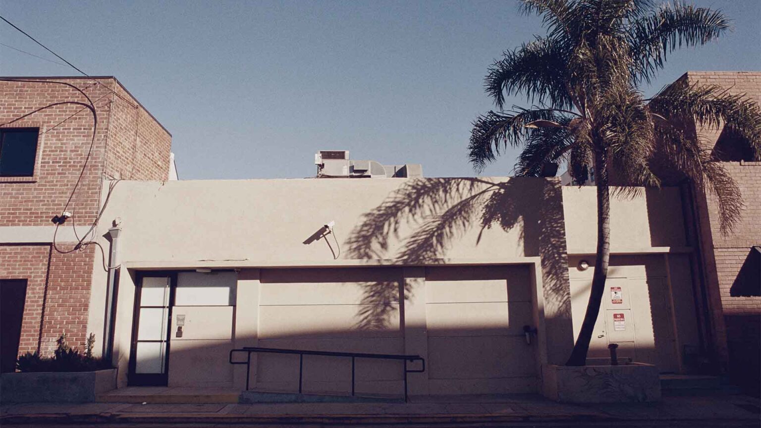 Palm-lined approach with a sense of privacy - unassuming and full of potential.